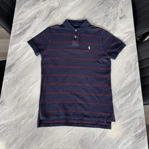 Original phone photo of a striped Polo Ralph Lauren shirt on a marble floor