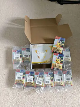 A Pokémon 30th Celebration Elite Trainer Box with a spread of Booster Bundles