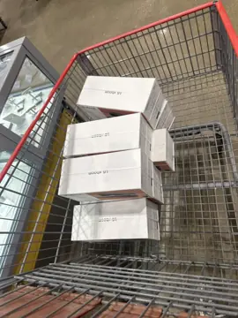 A Costco trolley stacked with LG xboom speaker boxes